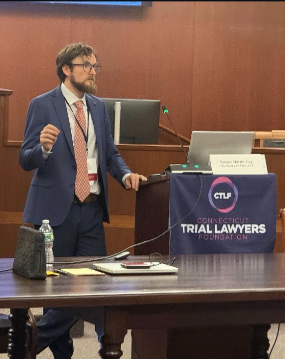 Attorney Wolf Martin standing in a professional law office with a focused, confident expression