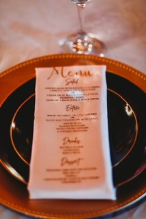 Outdoor garden wedding reception with string lights and long tables