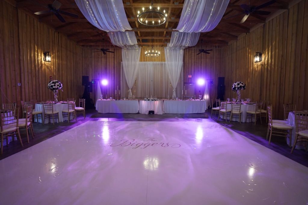 Grand ballroom with crystal chandeliers and round tables set for a formal dinner