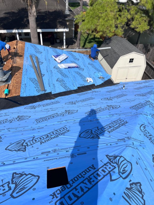 Completed roof installation with ridge vent and flashing details