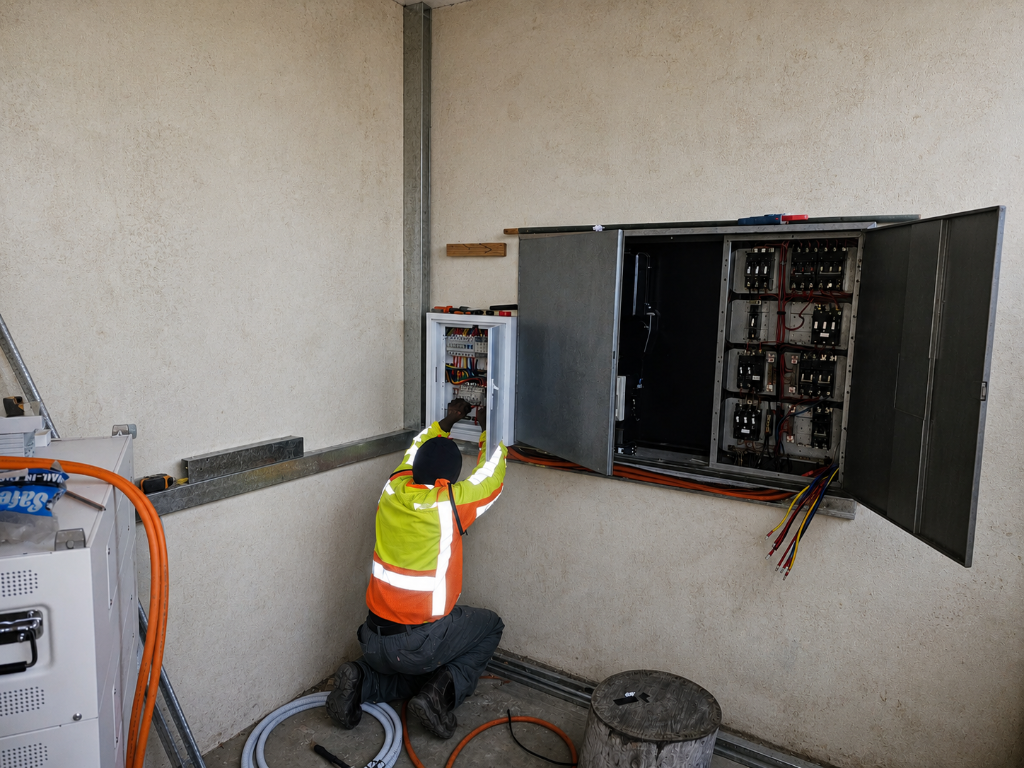 Construction crew working on a residential building site with scaffolding and tools